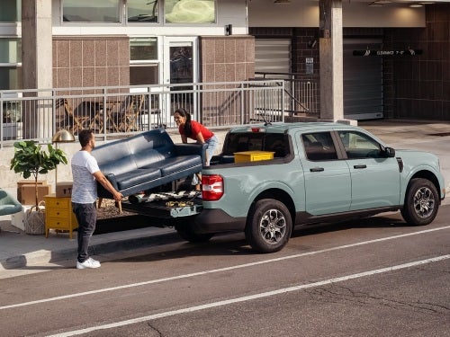 2024 Ford Maverick view of couple loading bed of truck with furniture