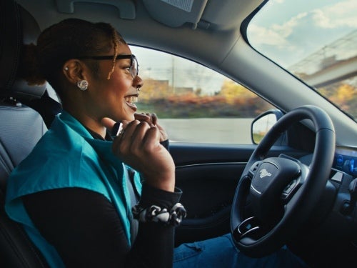 2024 Ford Mustang Mach-E view of woman in driver seat with hands off of wheel