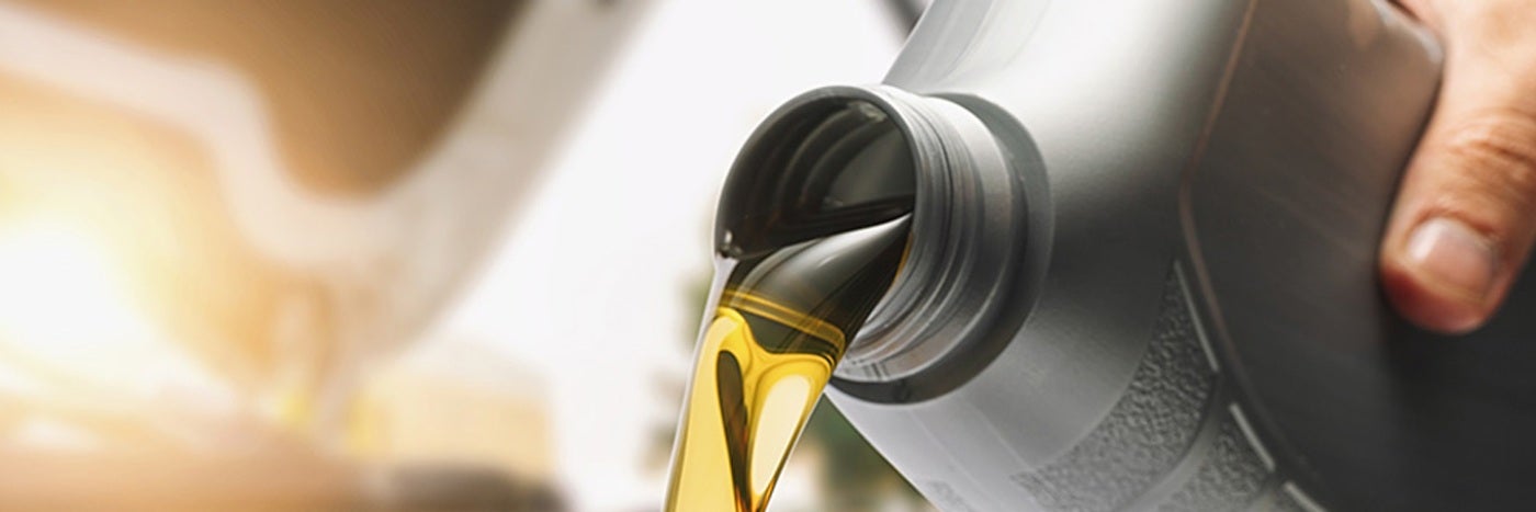 Close up view of auto oil being poured from a bottle